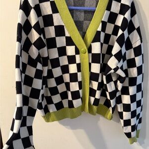 Checkered Black and White Sweater with Green Accents